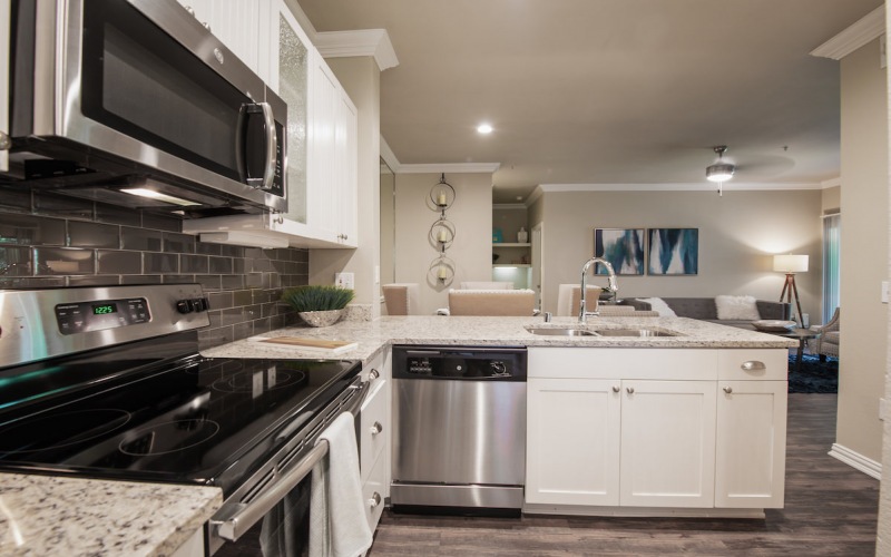 Model kitchen at our luxury apartments in Grapevine, TX, featuring stainless steel appliances and granite countertops.